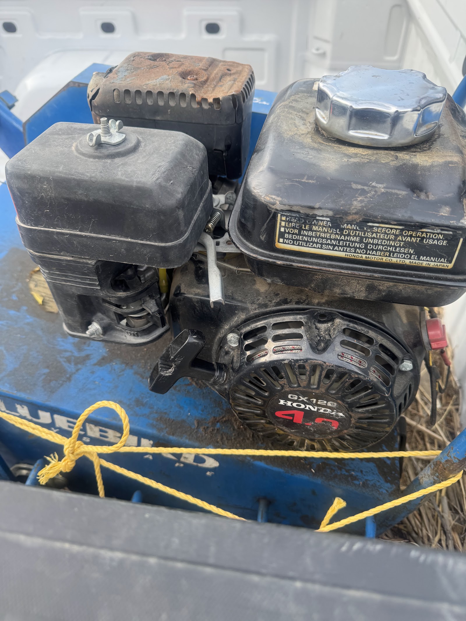 Honda GX engine on a Bluebird aerator being serviced
